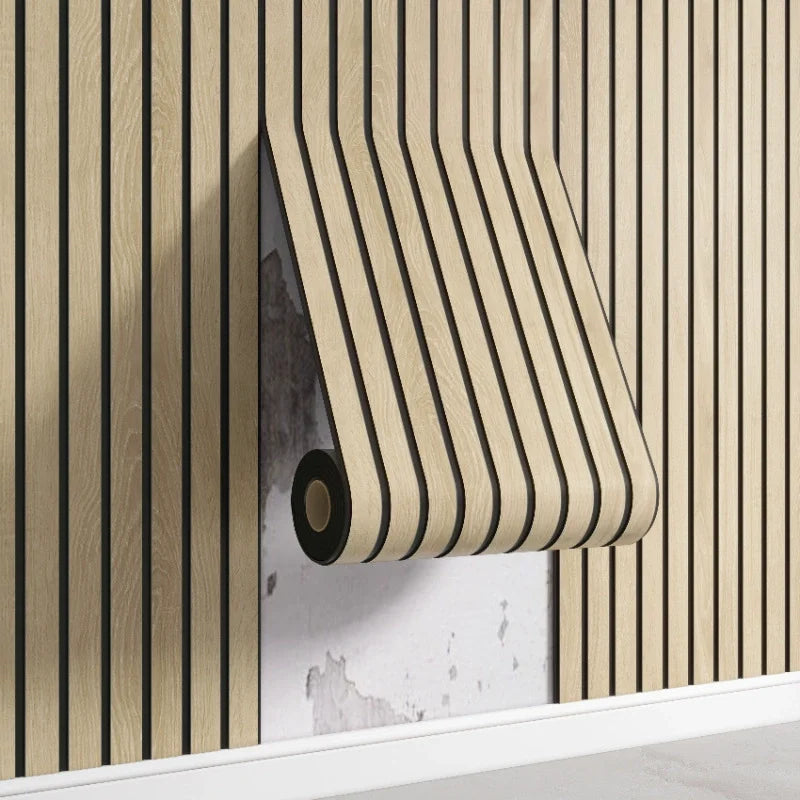 A close-up of a beige wood grid peel-and-stick wall panel installed on a vertical wooden slat background.