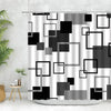 Geometric black and white fabric shower curtain featuring various square and rectangular shapes.