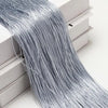 Silver beaded thread curtain hanging, showing the long strands draped over white boxes.