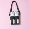 A black breathable mesh crossbody water bottle carrier with two white and black striped bottles.