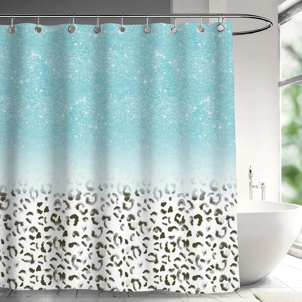 A light blue and teal abstract geometric shower curtain with a leopard print border hanging on a rod.