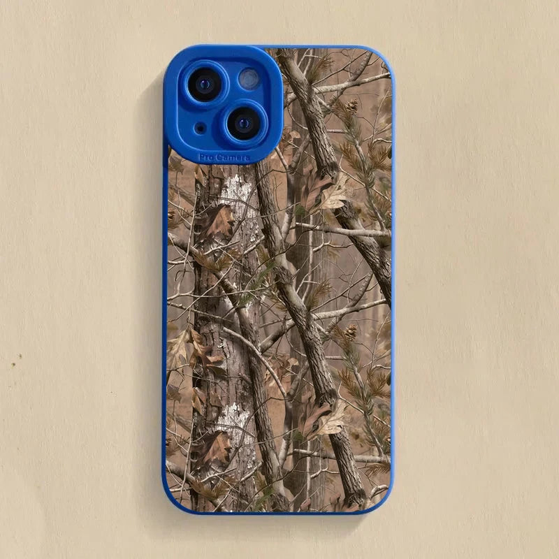 A blue silicone phone case featuring a forest camouflage pattern of tree branches and leaves.