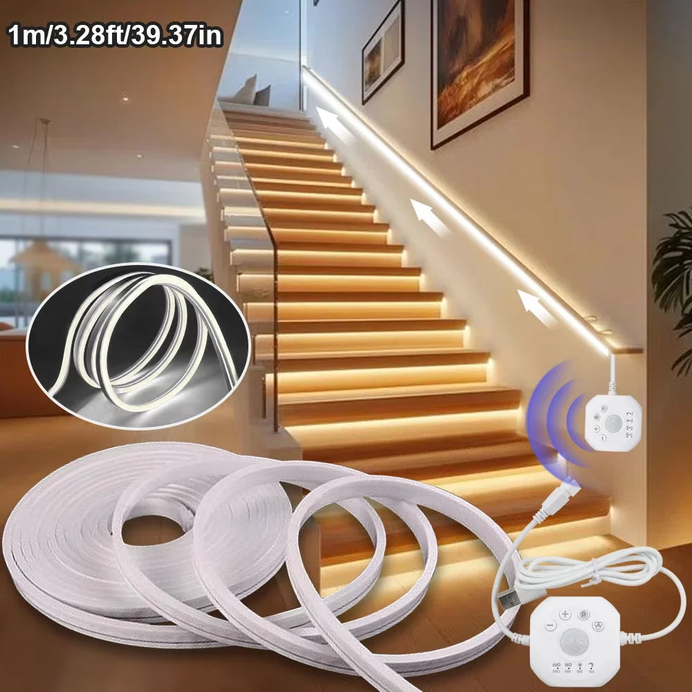 A roll of white LED motion sensor light strip with a control module shown next to a modern staircase.