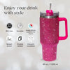 A pink rhinestone tumbler with a straw and handle is shown against a white background.