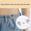 A close-up of a silver butterfly hook being used to adjust the waist of a denim jean skirt.