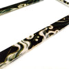 A pair of racing style license plate frames featuring a black and white marbled pattern with a JDM aesthetic.