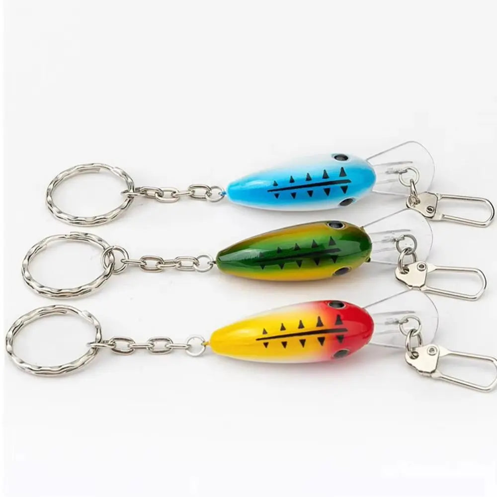 A set of three realistic fishing lure keychains featuring brightly colored lures on silver split rings.