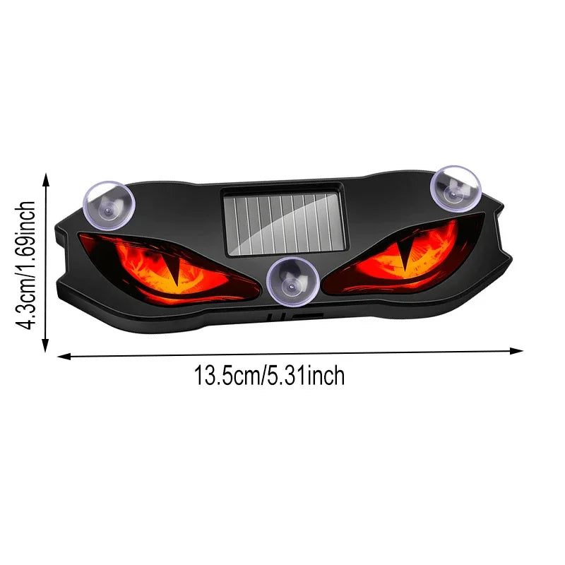 Black solar-powered devil eye LED rear window warning light with multiple lenses and a solar panel.