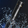 A black LED flashlight is shown being tested for waterproof durability, with water splashing around it.