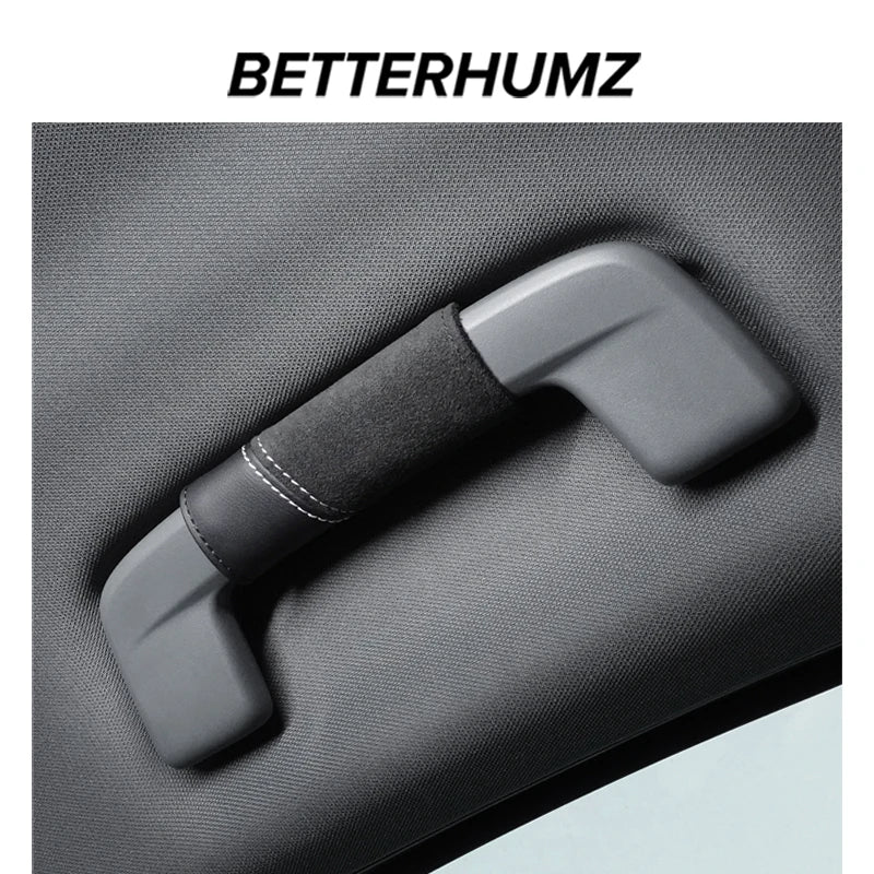 A close-up of a gray Audi Alcantara grab handle protector cover with a card pocket.