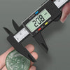A hand holds a digital caliper measuring a green leaf, displaying a measurement of 20.8 mm.