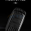A close-up view of a black carbon fiber style car key cover for VW and Skoda models.