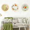 A set of floral cross stitch embroidery kits featuring various colored flowers and greenery on circular wooden boards.