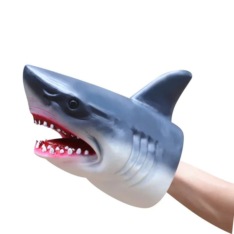 A realistic dinosaur hand puppet toy with a gray snout and pink gums, shown in profile.