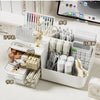 A white desk organizer featuring transparent drawers and compartments for pens, tools, and stationery.
