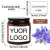 A dark glass jar with a custom logo label and blue wind chime decoration.