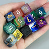 A hand holds a set of ten polyhedral dice in various colors and shapes for tabletop role-playing games