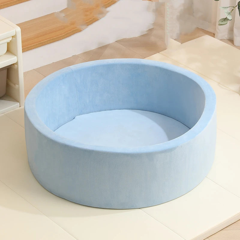 A light blue plush ball pit playpen with a surrounding floor mat for children.