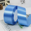 A roll of smooth, light blue satin ribbon used for gift wrapping or crafts.