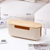 A light wood and cream cable management box organizer for desk and home use.