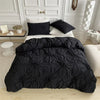 Black luxury duvet cover set with a 3D twist floral pinch-pleated design displayed on a bed.