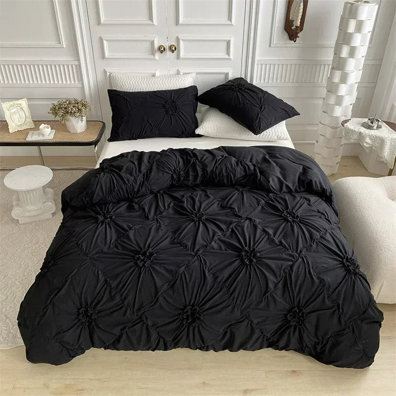 Black luxury duvet cover set with a 3D twist floral pinch-pleated design displayed on a bed.
