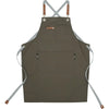 A dark olive green adjustable cotton canvas apron with multiple pockets and leather ties.