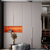 A modern interior featuring light wood grain wall panels and an orange shelf with a decorative sculpture.