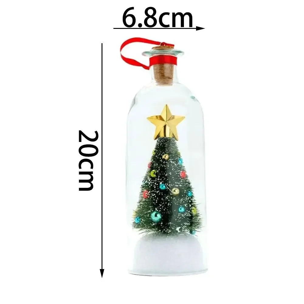 A clear glass message bottle shaped like a Christmas tree with a gold star topper and snowy scene inside.