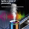A rechargeable car aroma diffuser with a colorful light is placed on a dark car interior surface.