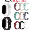 Various silicone replacement straps for Mi Band 10, 9, and 8 in white, pink, and green colors.