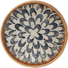 Handcrafted rattan serving tray with mother of pearl inlay featuring a circular pattern.