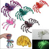 A collection of colorful, fuzzy pet toys including spiders and a yellow textured toy.