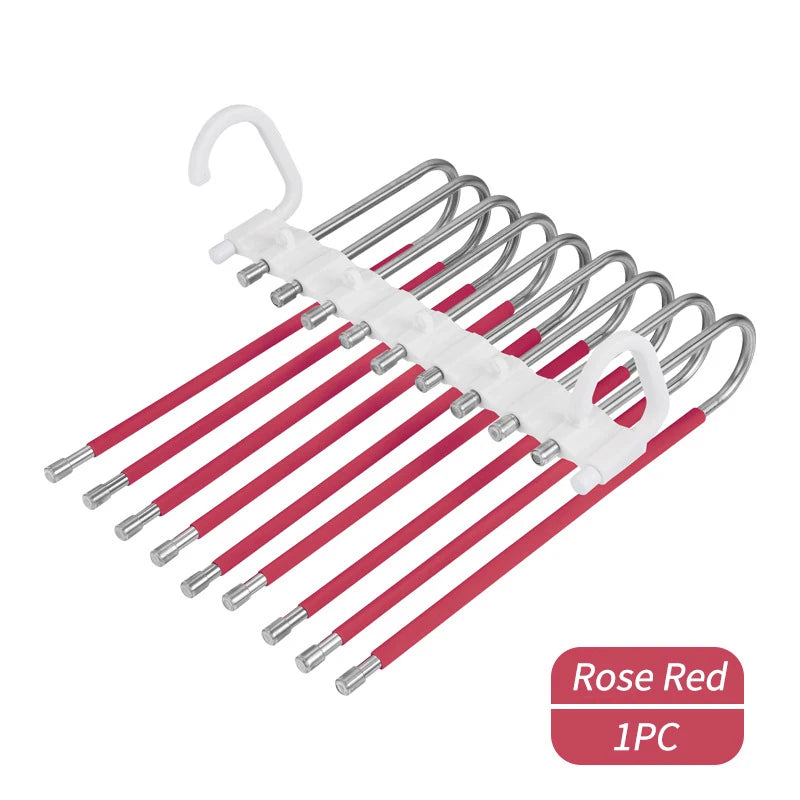 A set of nine stainless steel pants hangers with a white non-slip grip and red plastic arms.