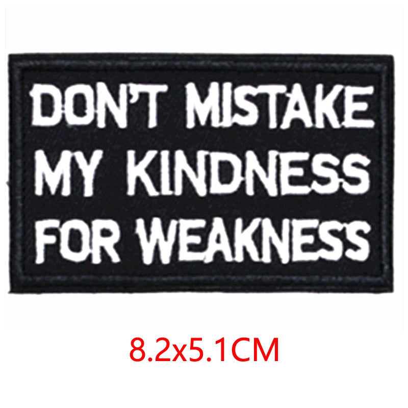 Black embroidered iron-on letter patch with white text that reads Don't mistake my kindness for weakness