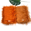 Two bundles of bright orange faux fur fabric for DIY sewing, doll hair, and cosplay