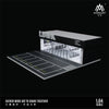 A 1:64 scale miniature garage diorama kit featuring a black and white checkered floor and interior lighting.