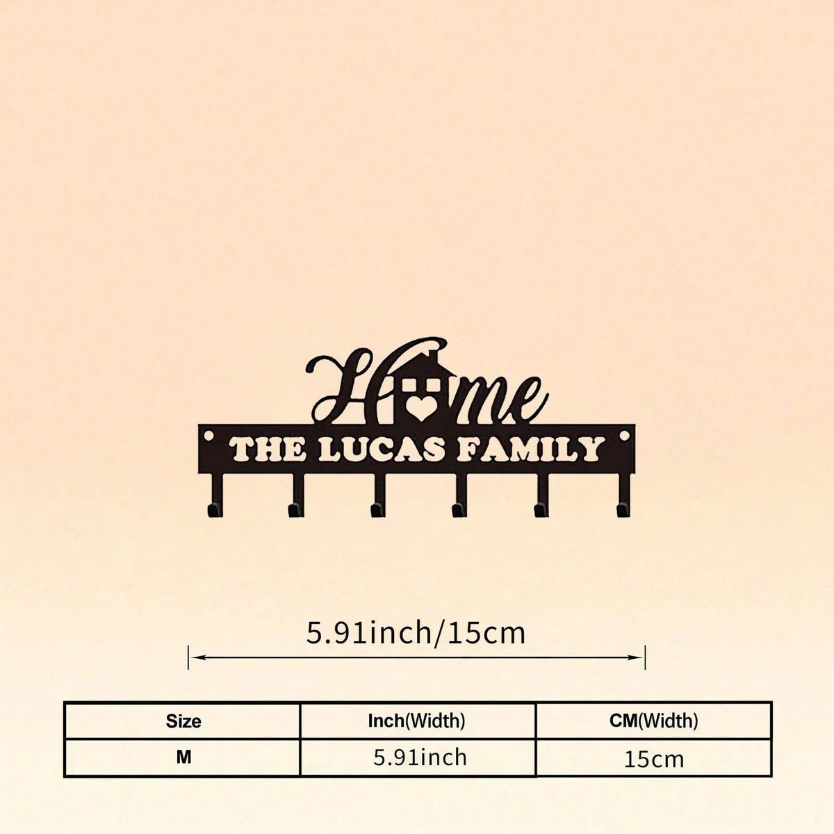 A black silhouette design featuring the words Home The Lucas Family above a row of iron wall hooks.