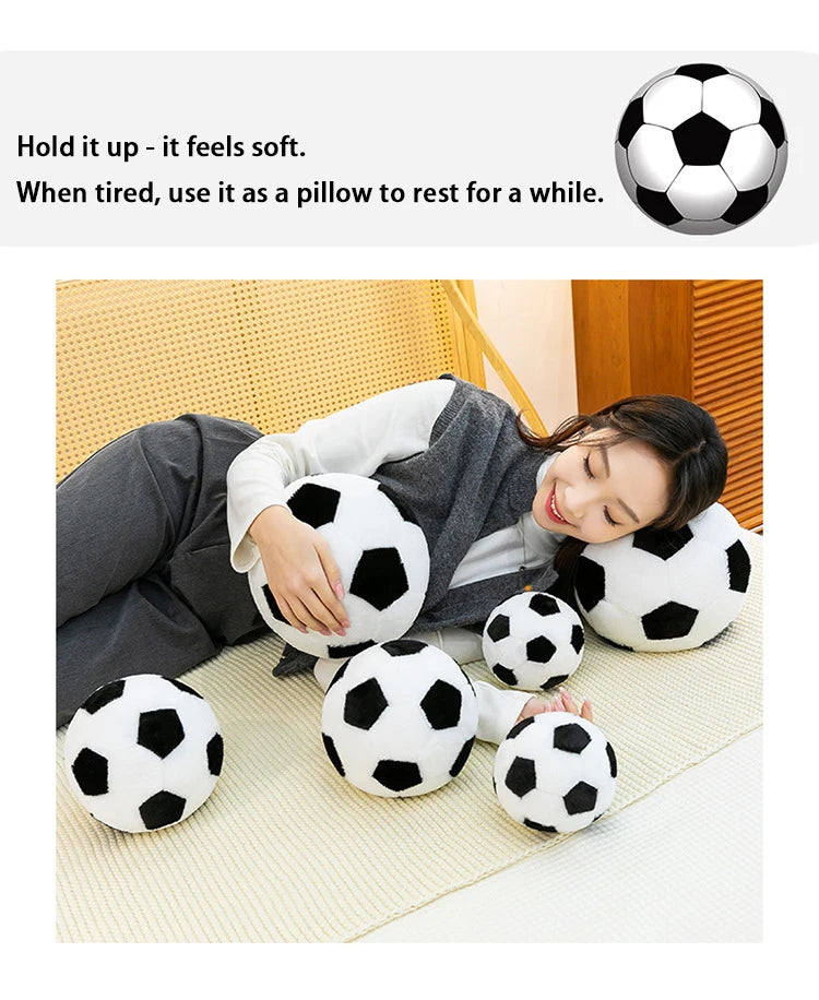 A woman rests her head on a collection of soft, black and white football plush pillows.