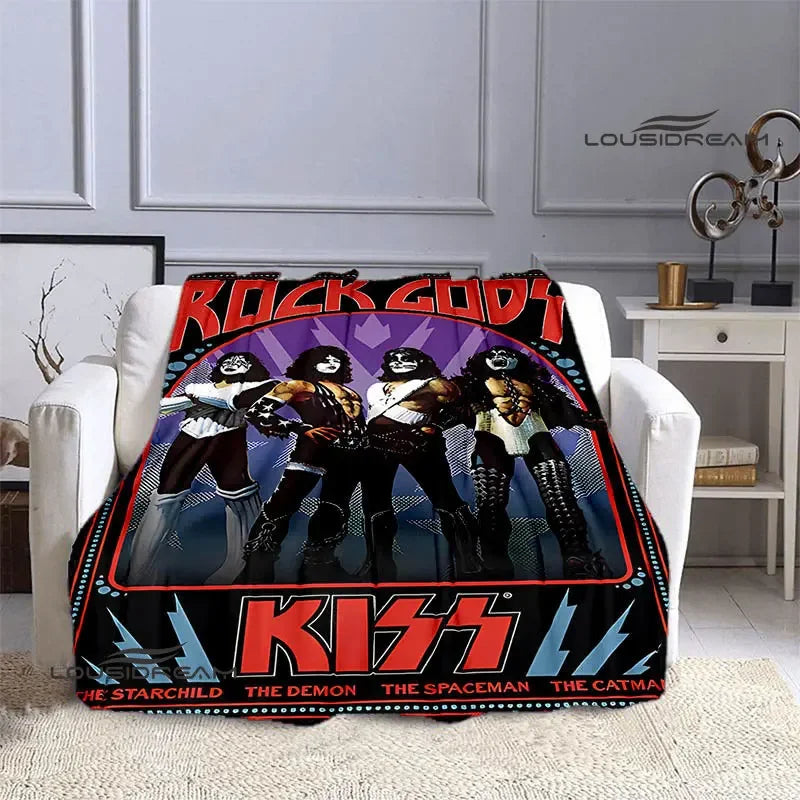 A black and red printed flannel throw blanket featuring the Kiss band members and related imagery.