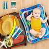 A baby is sitting in a blue inflatable water play mat surrounded by toys and a folded mat.