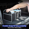 A hand places a black and white foldable car trunk organizer with three compartments into the trunk of a vehicle.