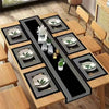 A set of waterproof geometric table runners and placemats featuring a black and gold design on a wooden table.