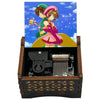 A music box featuring an anime character from Cardcaptor Sakura, with a colorful illustration and wooden casing.