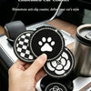 A hand holds a set of light luxury diamond-embedded car coasters featuring a camellia paw pattern in a car cup holder.