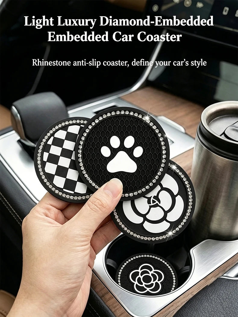 A hand holds a set of light luxury diamond-embedded car coasters featuring a camellia paw pattern in a car cup holder.