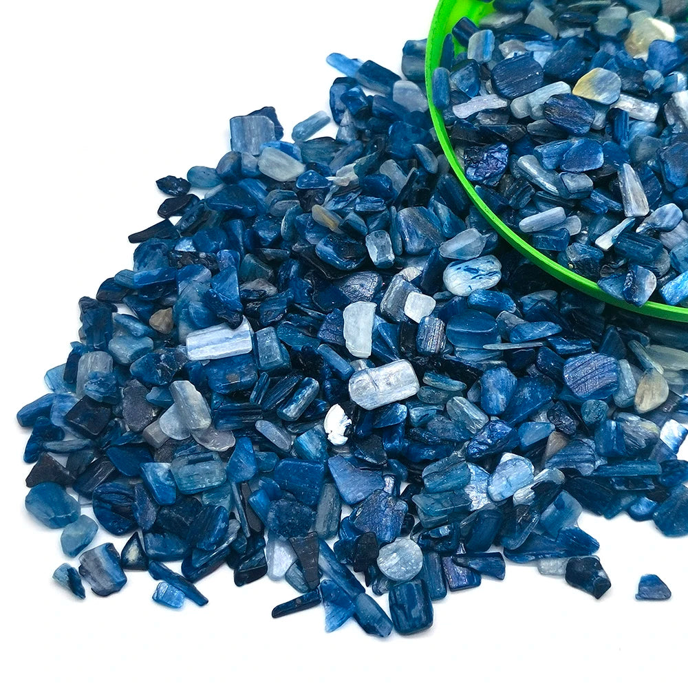 Dark blue tumbled crystal stone chips scattered on a green bowl