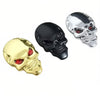 Three chrome skull emblems in gold, black, and silver finish.