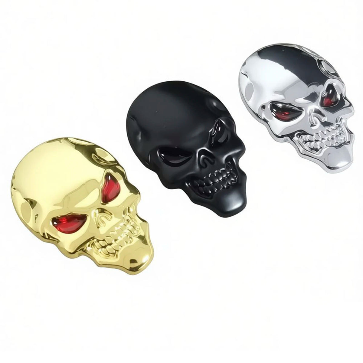 Three chrome skull emblems in gold, black, and silver finish.