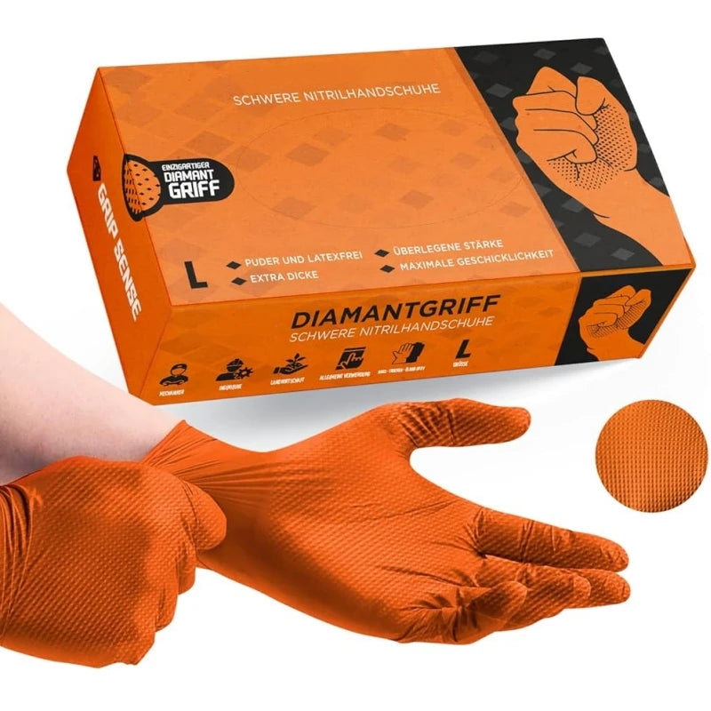 Box and orange nitrile gloves with diamond texture shown next to a hand